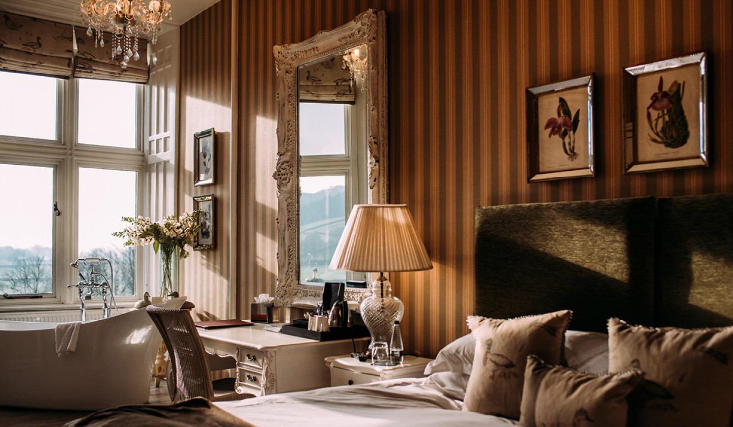 Opulent guest room with free standing bath in the window